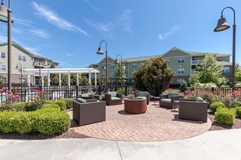 Outdoor fireside lounge with summer kitchen and al fresco dining area